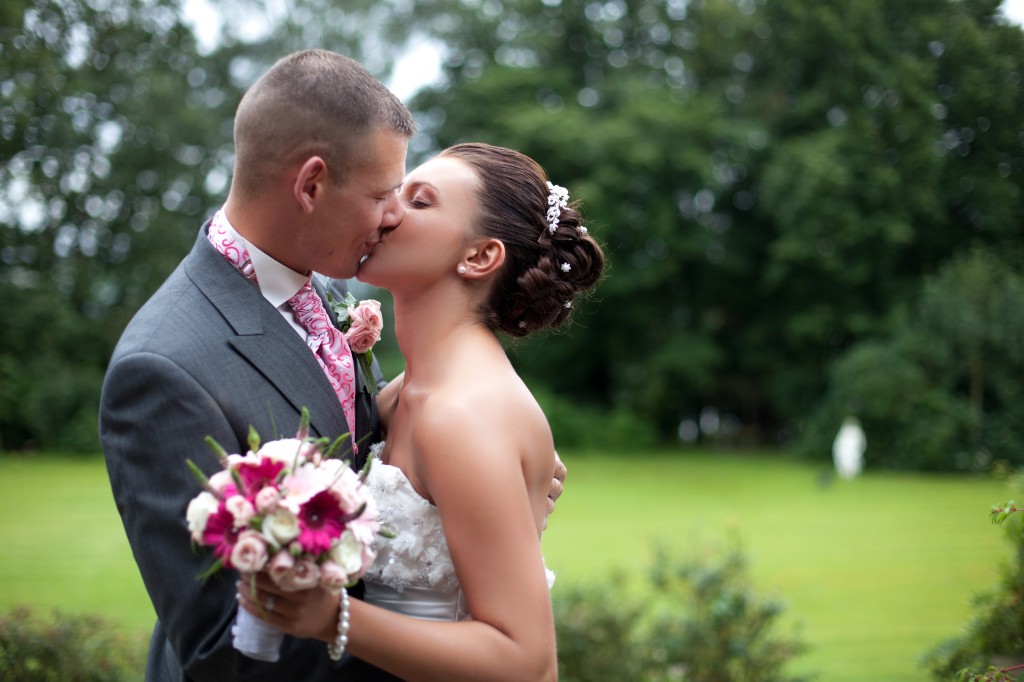 A bride and groom kissing during couples portraits at Higher Trapp