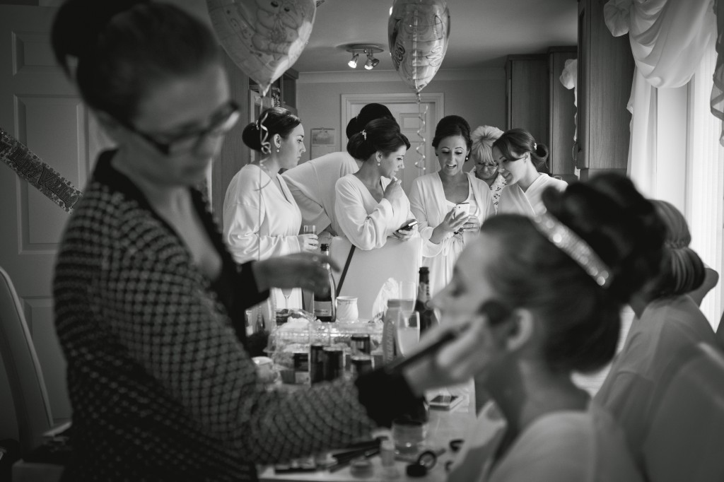 Bridesmaids share a secret text during bridal preparations. Beautiful Wedding Photography Liverpool