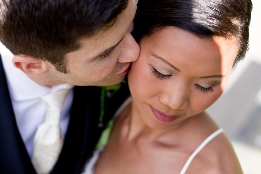 Close up of a tender kiss from a groom to his new bride. Wedding Photography