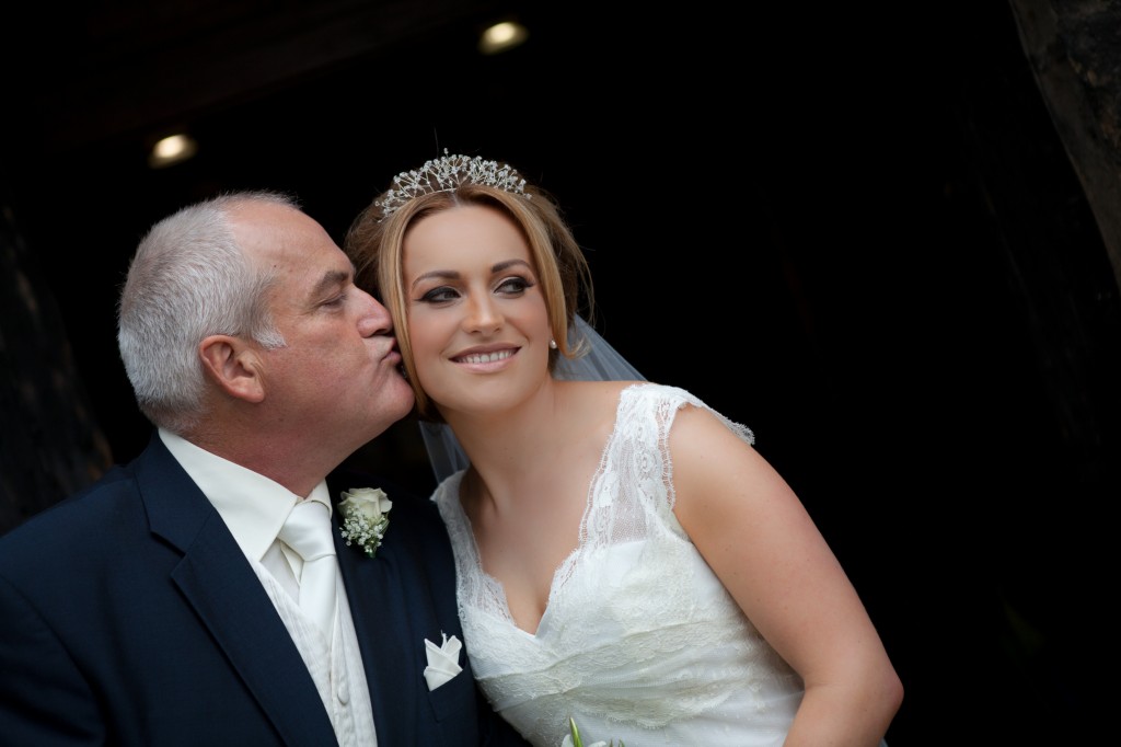 Father of the bride kisses his daughter on the cheek, beautiful wedding photography Lancashire