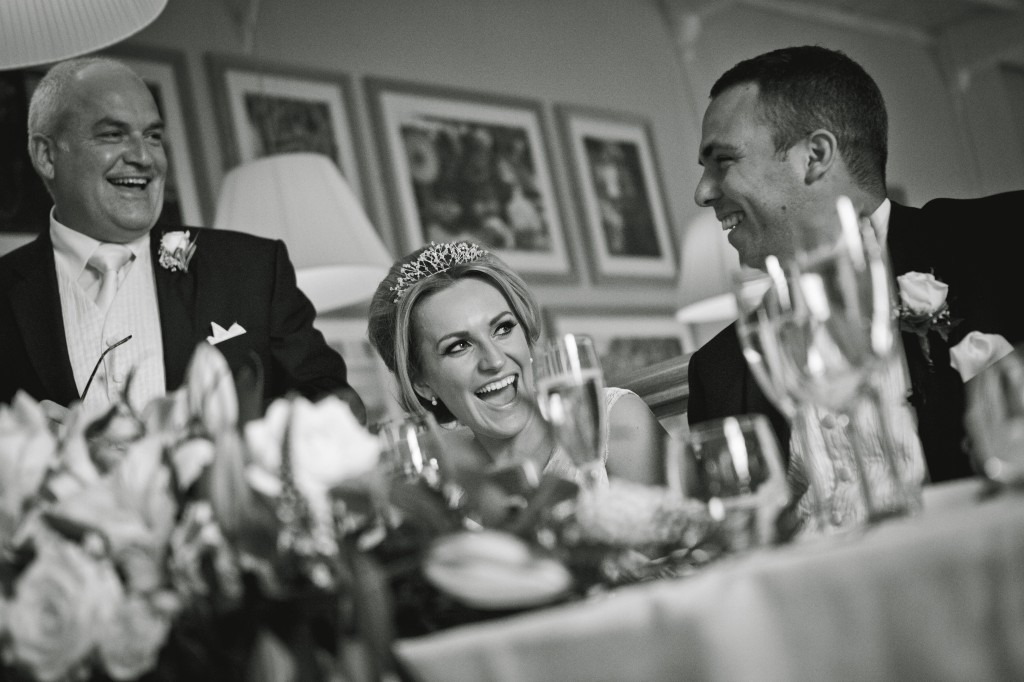 Black and white shot of Father of the Bride, the bride and groom at the top table, Lancashire photography