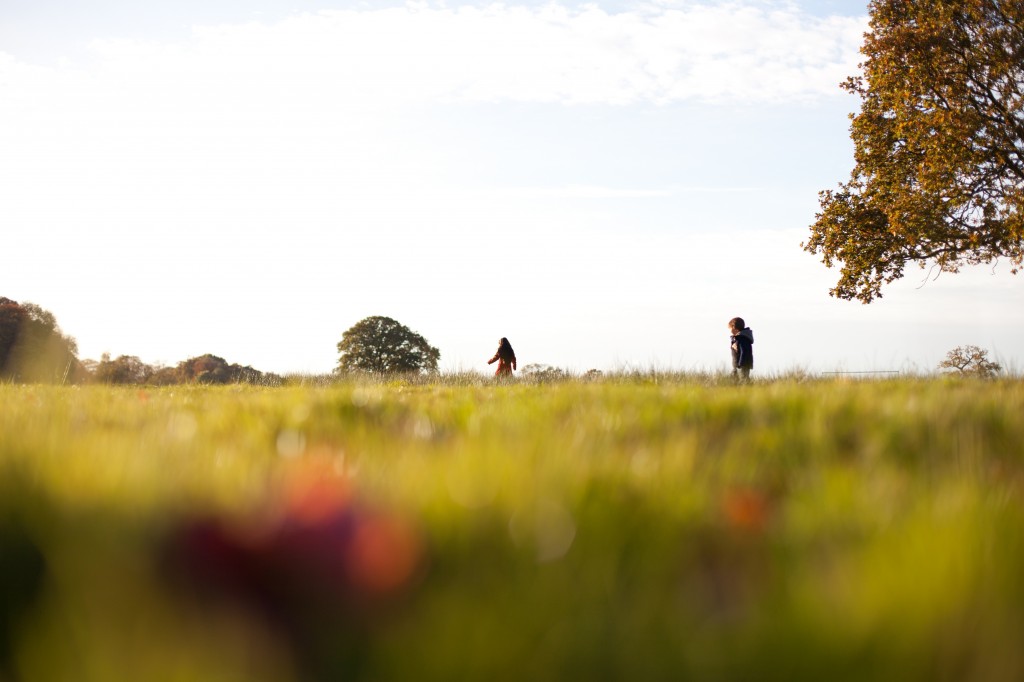 Two siblings run across a field in the sun during a Lifestyle Photography Shoot, Preston Lancashire