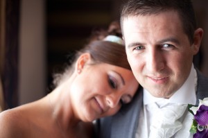 Bride Lays Head on Groom's Shoulder | Suites Hotel Wedding Photographer