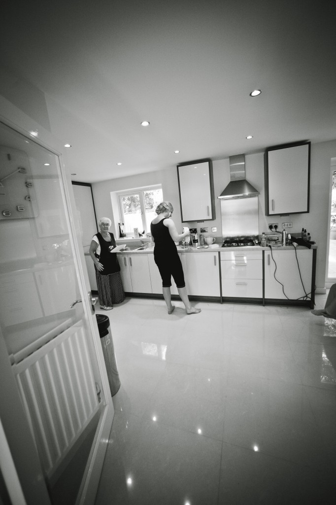 Documentary Wedding Photography, a shot of a bridesmaid getting some food in the kitchen
