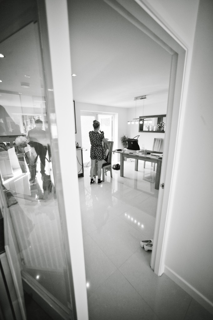 Documentary wedding photography, looking in with a wide angle lens to include doorway
