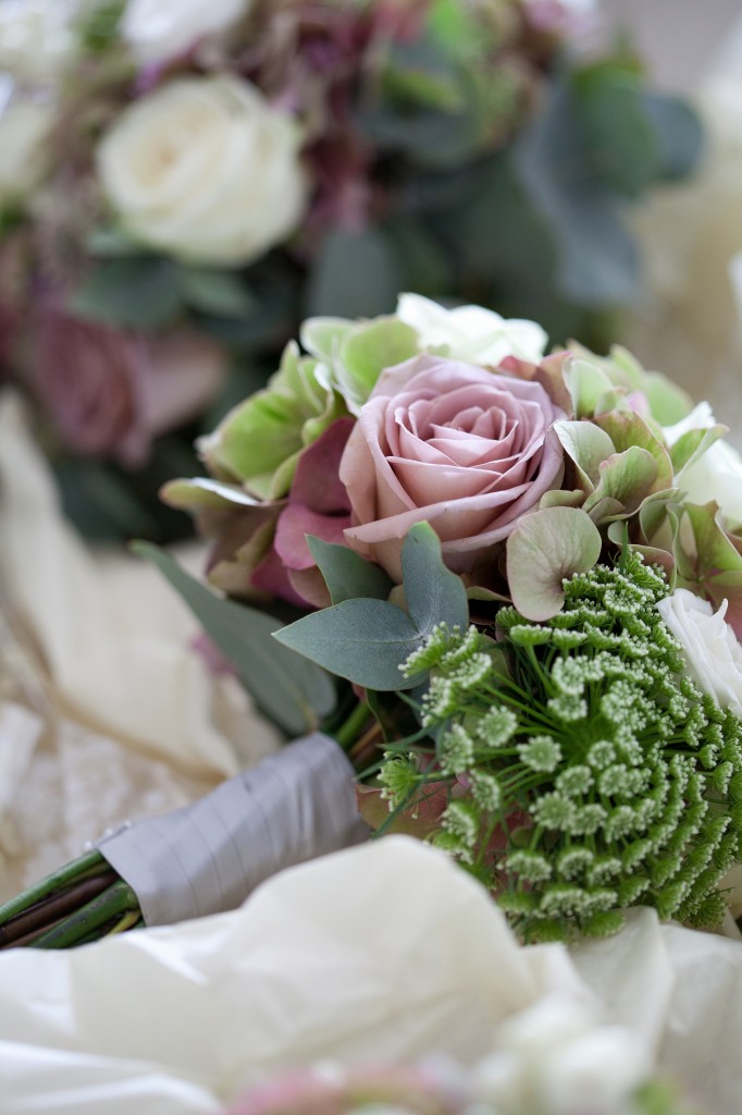 Gorgeous pink rose nestled in with other flowers in a bridesmaid bouquet, Lancashire wedding photography