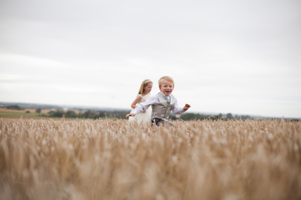 Boy and girl running across a field at West Tower, Lancashire Wedding Photography