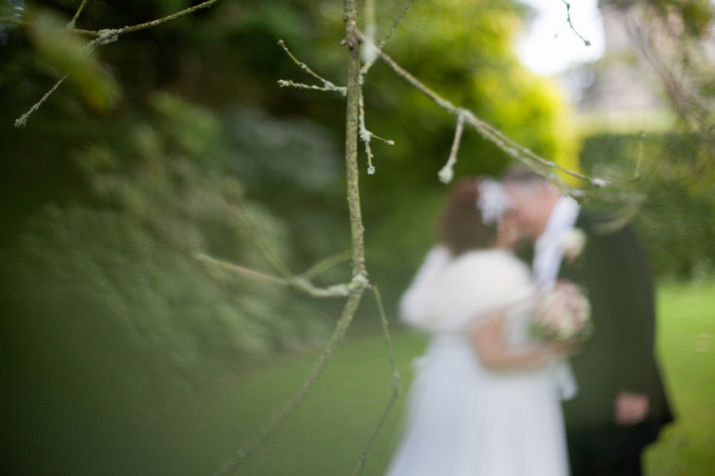 Creative photograph of tree with bride and groom out of focus