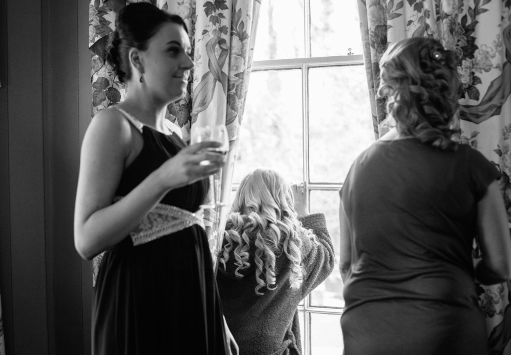Bridesmaid looks out of window