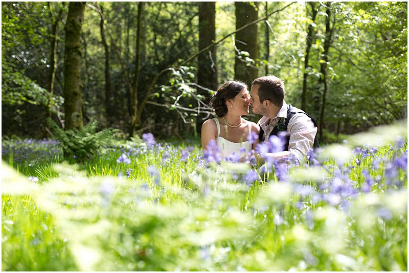 A couple sit in Bluebells wedding photography