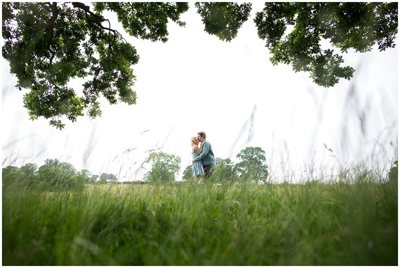 Bride and groom in field during pre wedding shoot at Sandhole