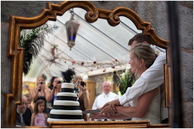 Bride and groom cutting the cake at Wedding in Wales