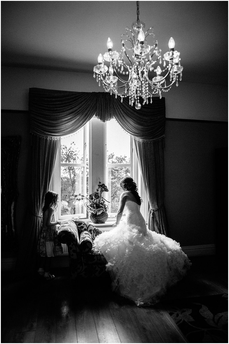 Bride looks out window at West Tower Lancashire Photography