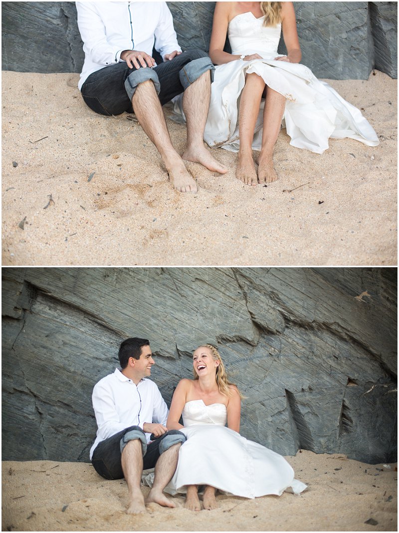 Sitting in Cornwall sand a bride and groom in love