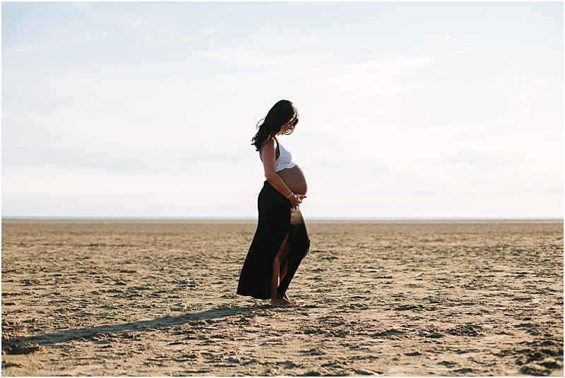 Gorgeous pregnant woman on the beach during shoot