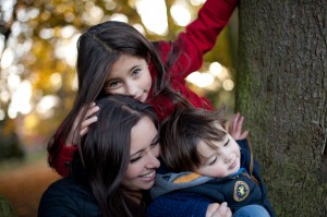 A family cuddle up close laughing in Preston, Lancashire during a family photo shoot