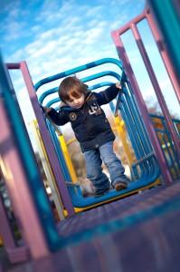 Little boy playing at Ashton Park, Preston during a family photo shoot