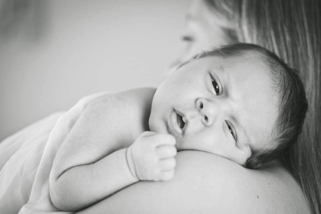 Laying on her mother's shoulder - newborn lifestyle photography