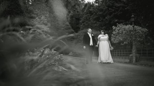Bride and groom walking hand in hand along a pathway, Lancaster, Lancashire