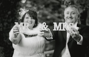 Mr & Mrs Sign being held up for creative wedding photography