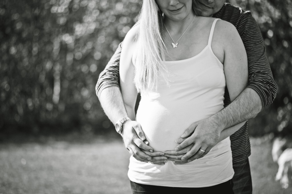 Loved. A husband cradles his wife and her pregnant belly - maternity lifestyle photography Lancashire