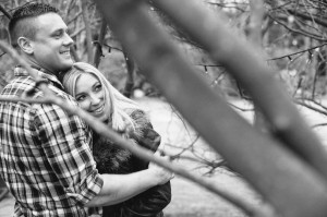 An engaged couple under trees at Pre wedding shoot Statham Lodge Cheshire