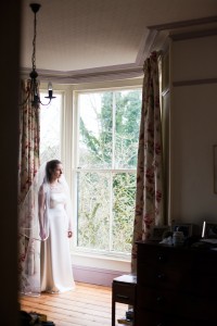 Bride standing in window - Lake District