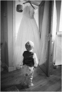 Son with wedding dress photo